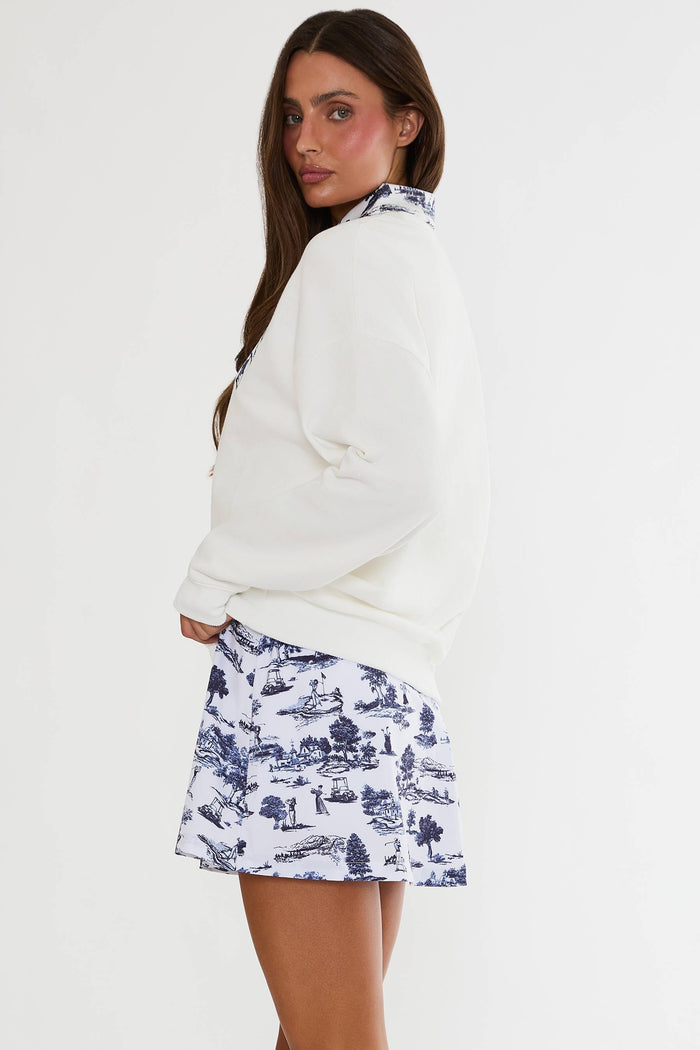 White sweatshirt with blue golf texting.