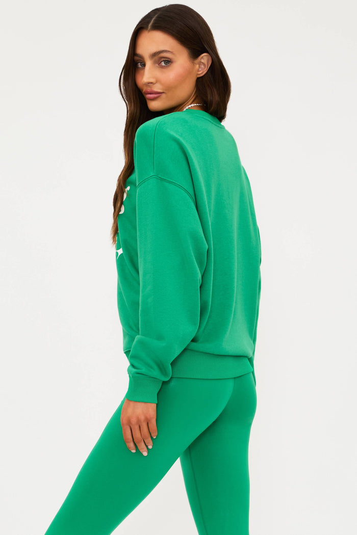 Woman wearing a green tracksuit on a white background