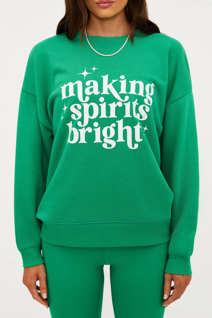 Green sweatshirt with 'making spirits bright' text on a white background