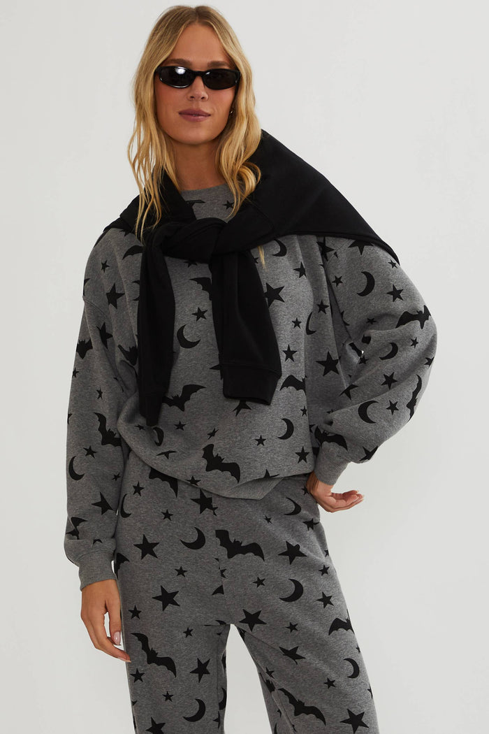 Grey oversized sweatshirt with black bats, stars, and moon.