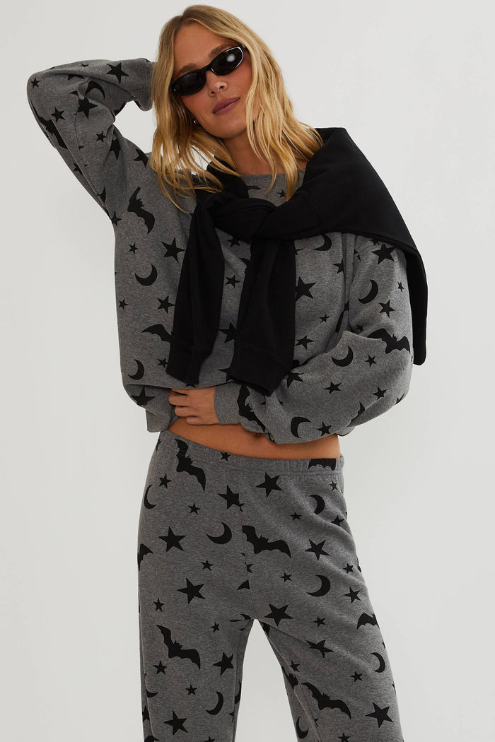 Grey oversized sweatshirt with black bats, stars, and moon.