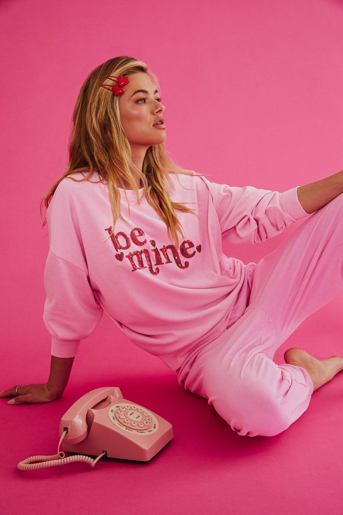 Pink sweatshirt with "be mine" in red sequin