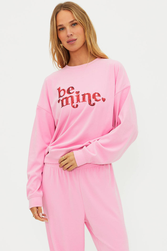 Pink sweatshirt with "be mine" in red sequin