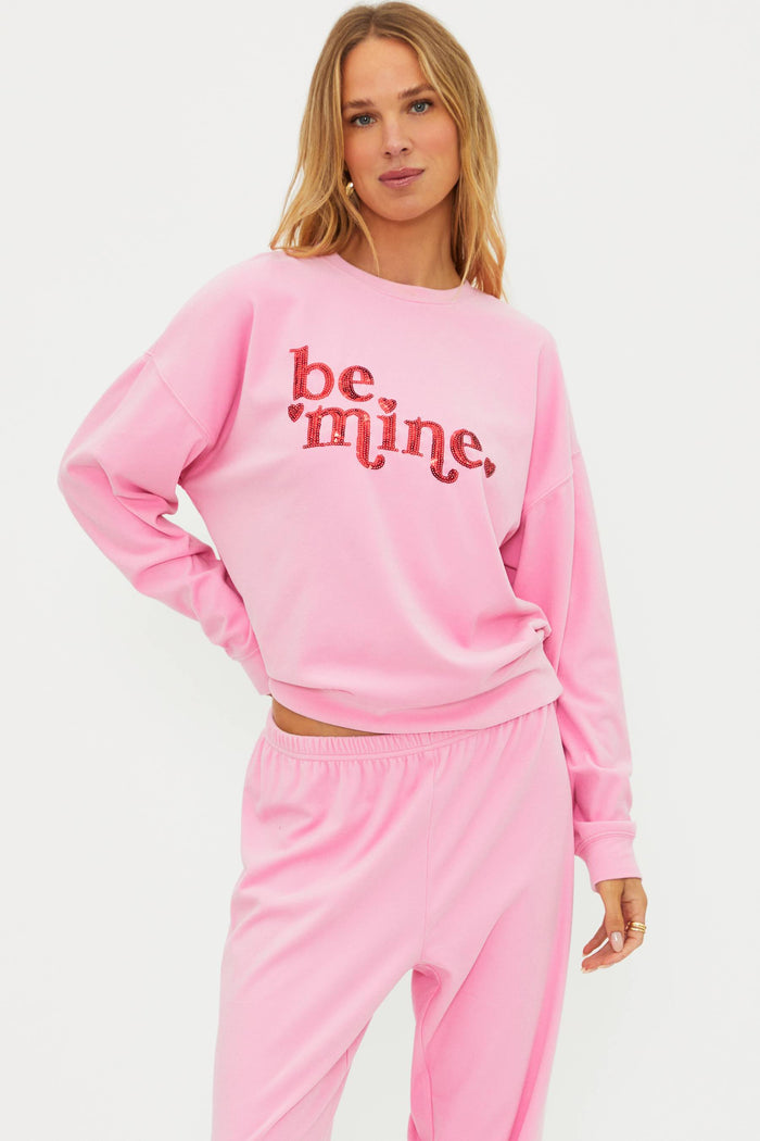 Pink sweatshirt with "be mine" in red sequin