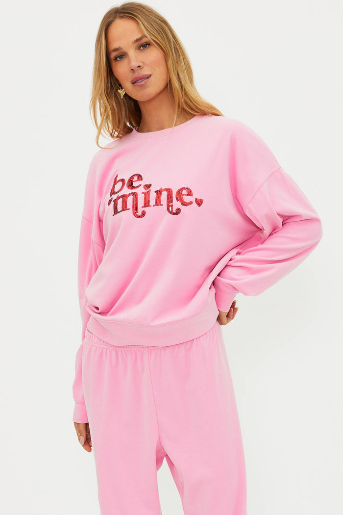Pink sweatshirt with "be mine" in red sequin