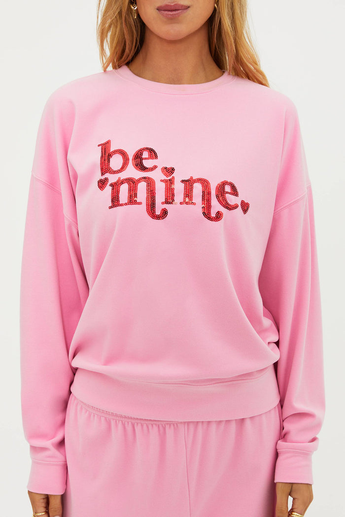 Pink sweatshirt with "be mine" in red sequin