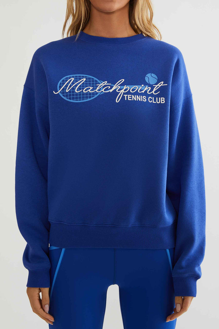 Royal blue sweatshirt with "matchpoint tennis club" text printed on the front.