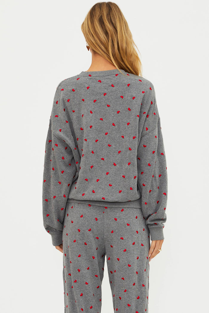 Grey sweatshirt with red hearts.
