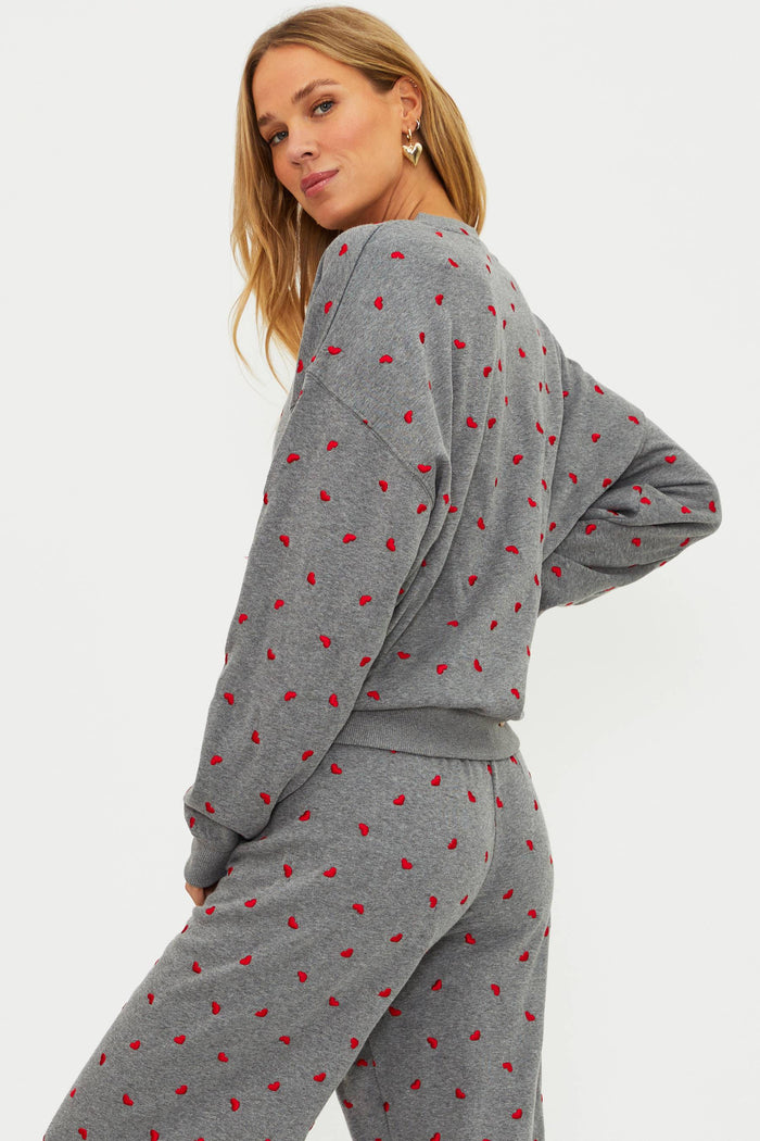 Grey sweatshirt with red hearts.