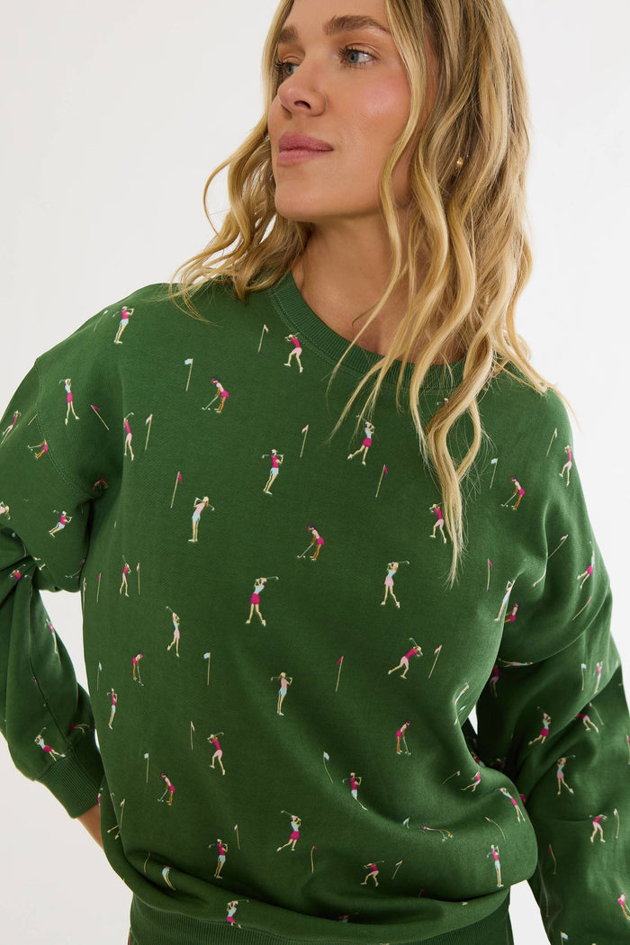 Woman wearing a green sweater with golf pattern on a white background