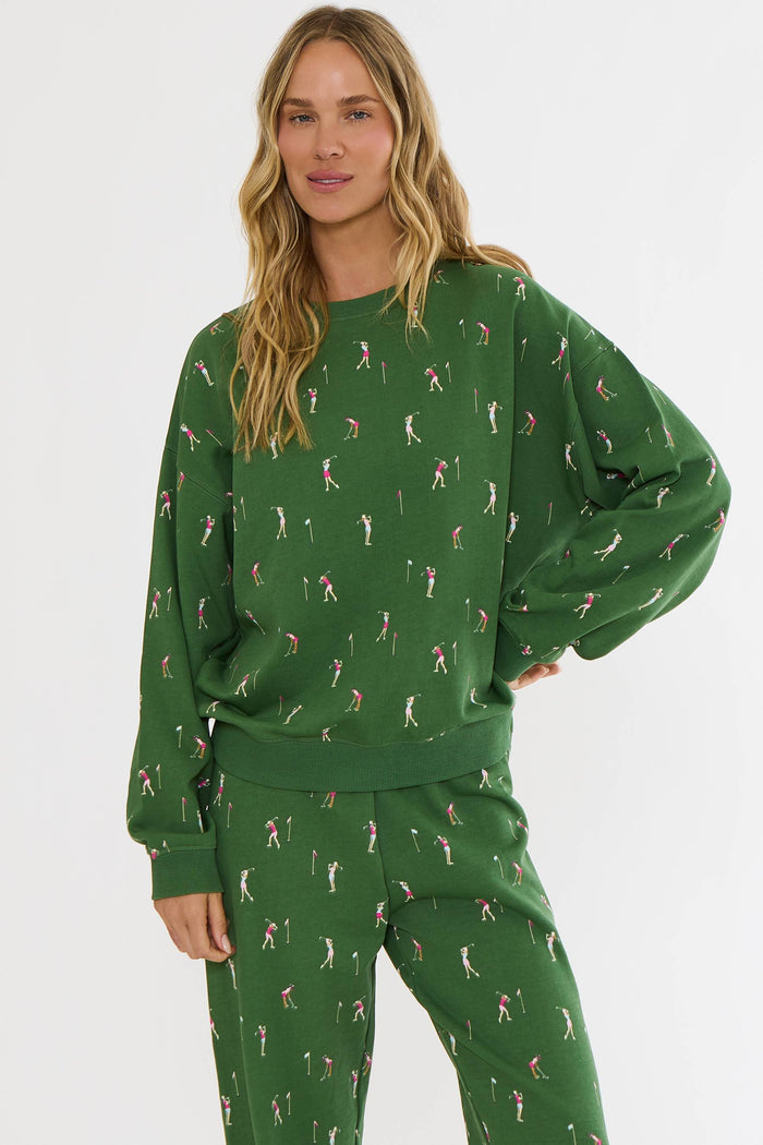 Woman wearing a green patterned outfit on a white background