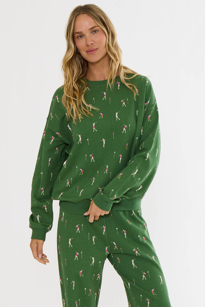 Woman wearing a green pajama set with a pattern on a white background
