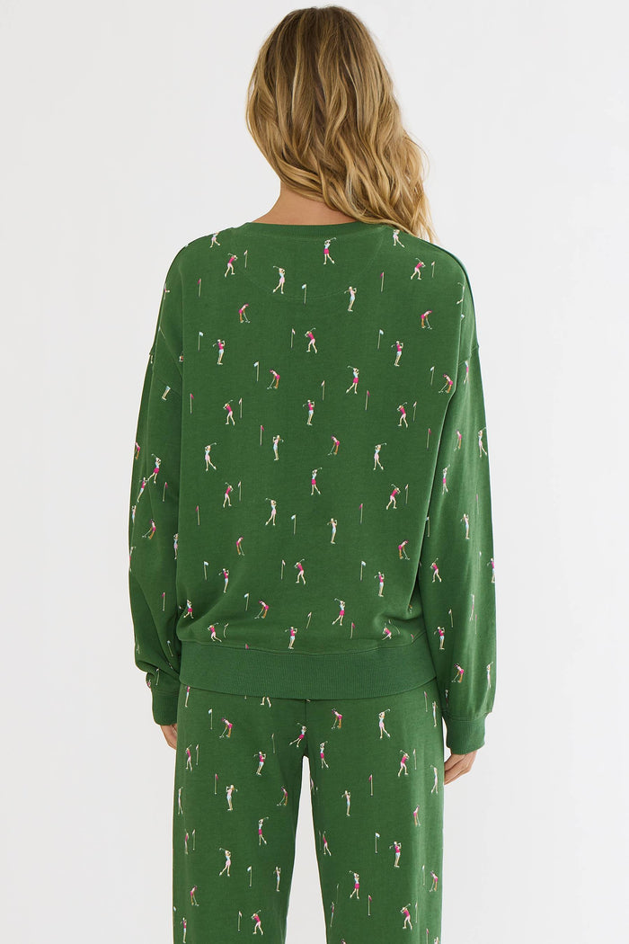 Green pajama set with a pattern of people playing golf on a white background
