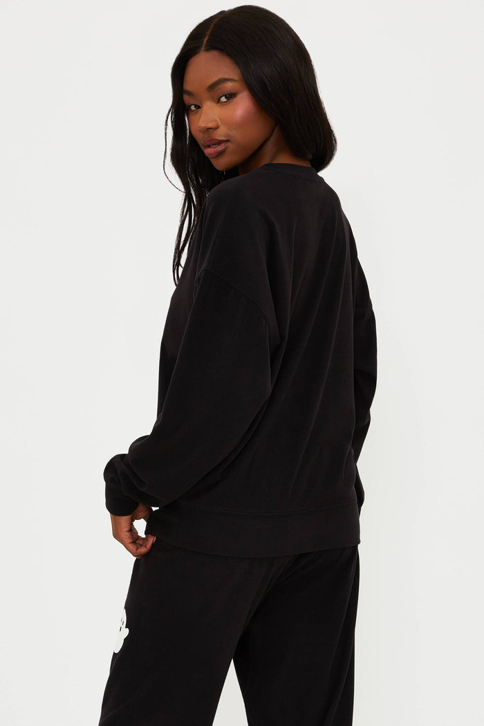 Person wearing a black outfit on a white background