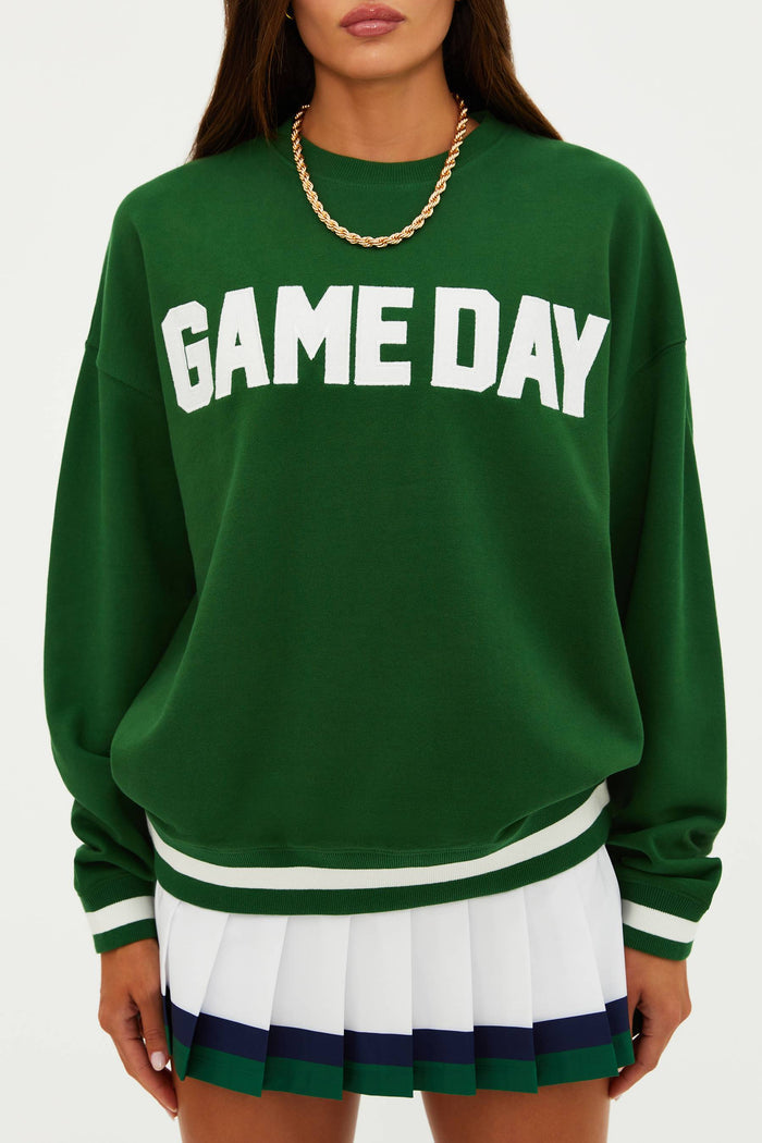 Green 'GAME DAY' sweatshirt worn by a person on a white background