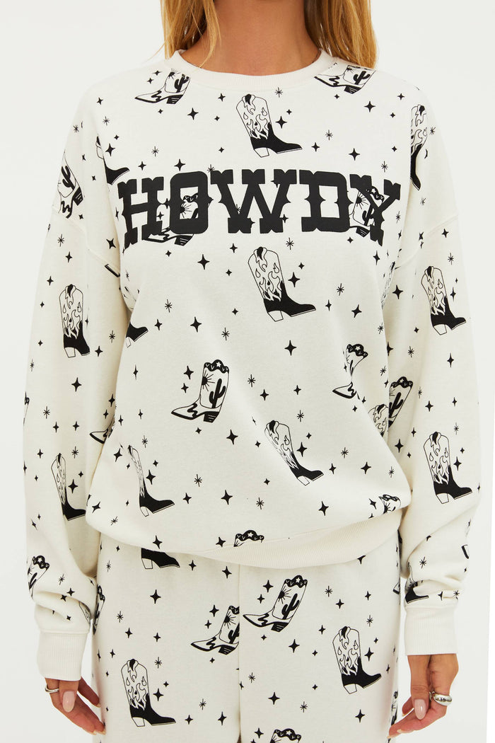 White sweatshirt with black cowboy boot and 'HOWDY' text pattern on a white background