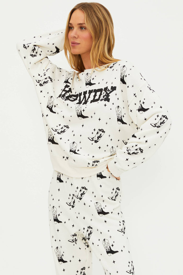 Woman wearing a white hoodie with black patterns and text on a white background