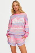 Woman wearing a colorful striped pajama set on a white background