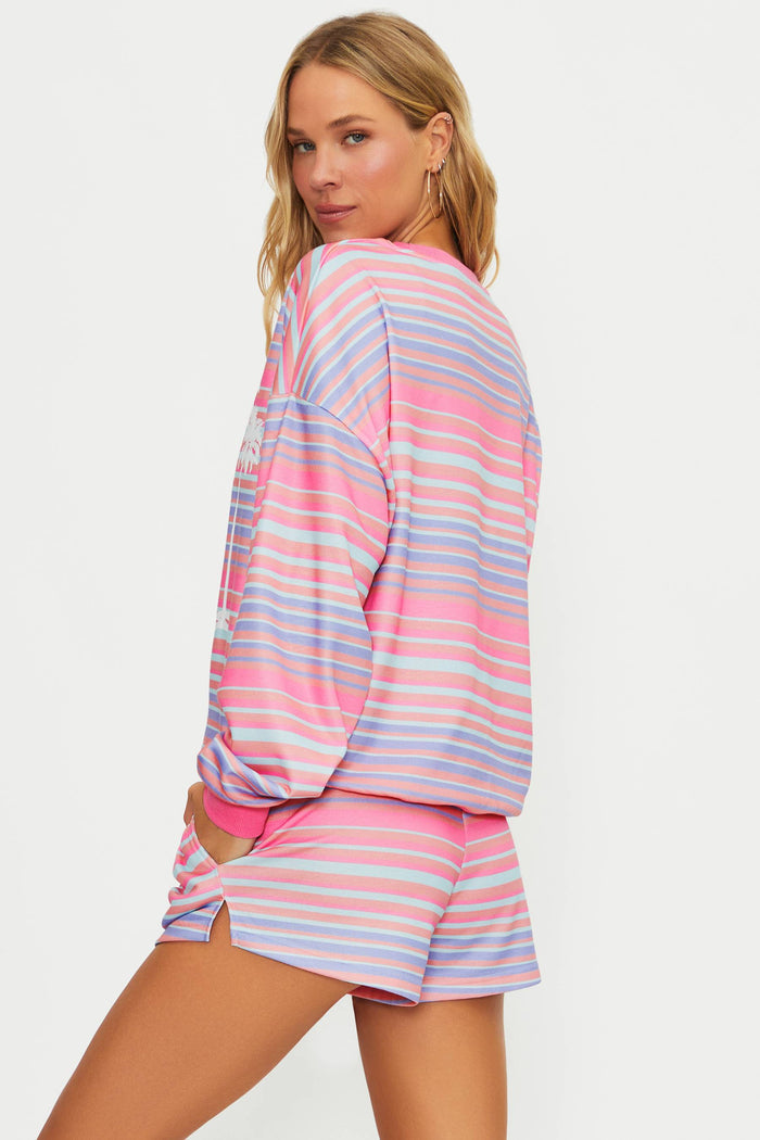 Woman wearing a colorful striped pajama set on a white background