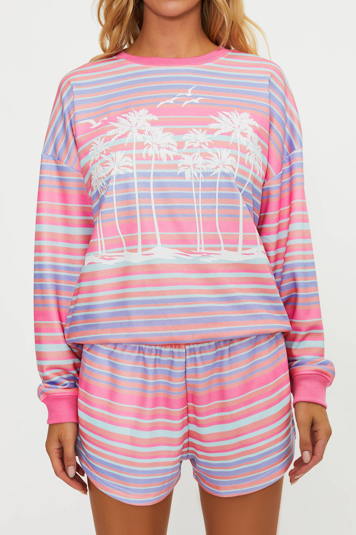 Woman wearing a colorful striped pajama set on a white background