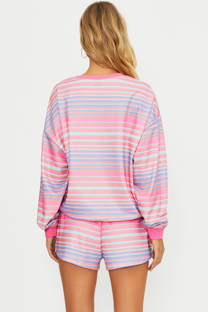Woman wearing a colorful striped pajama set on a white background