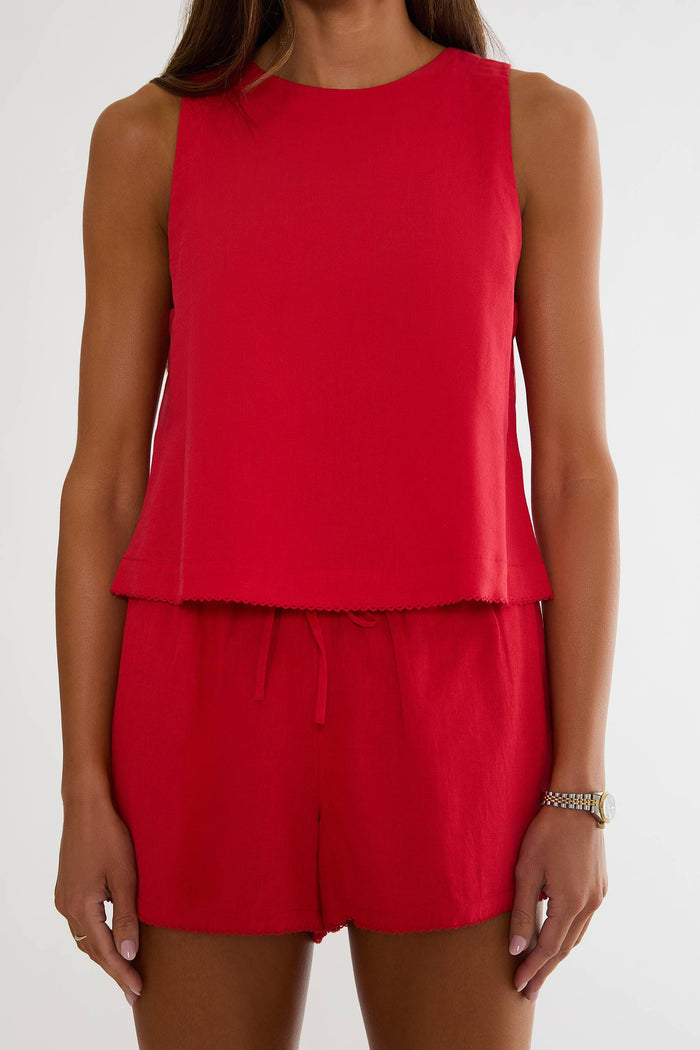 Red sleeveless top and shorts set on a white background