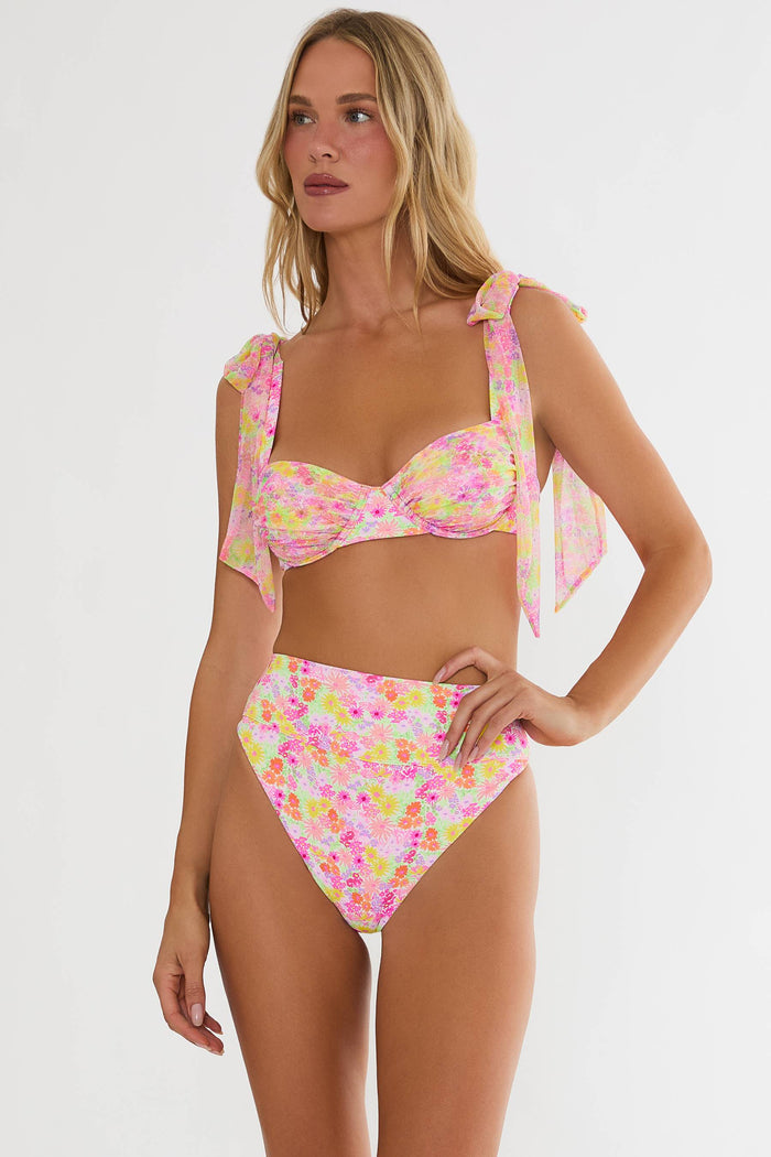 Woman wearing a colorful bikini set on a white background