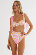Woman wearing a colorful bikini set on a white background