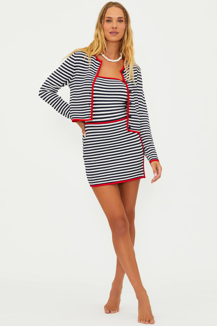 A model wearing a mini length, striped, cover-up skirt with contrast trim.