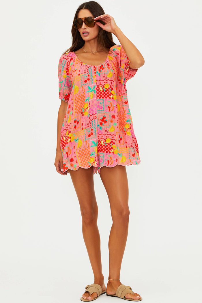 Woman wearing a colorful patchwork dress on a white background