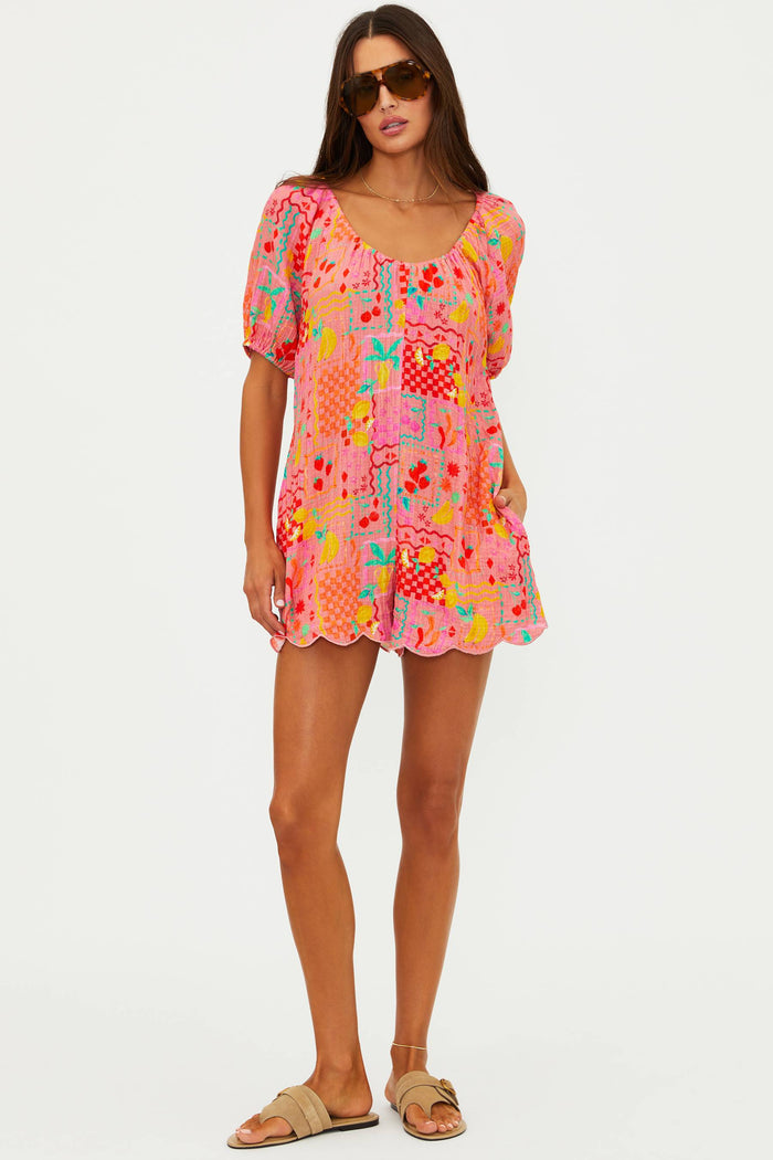 Woman wearing a colorful patterned dress on a white background