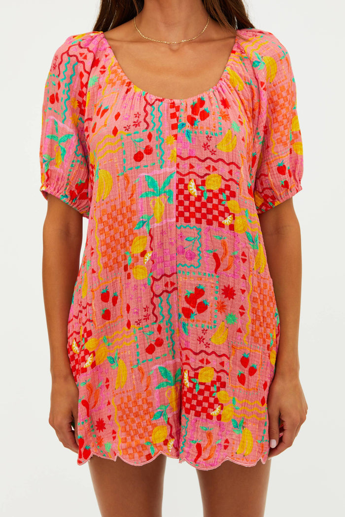 Colorful patterned dress worn by a person on a white background