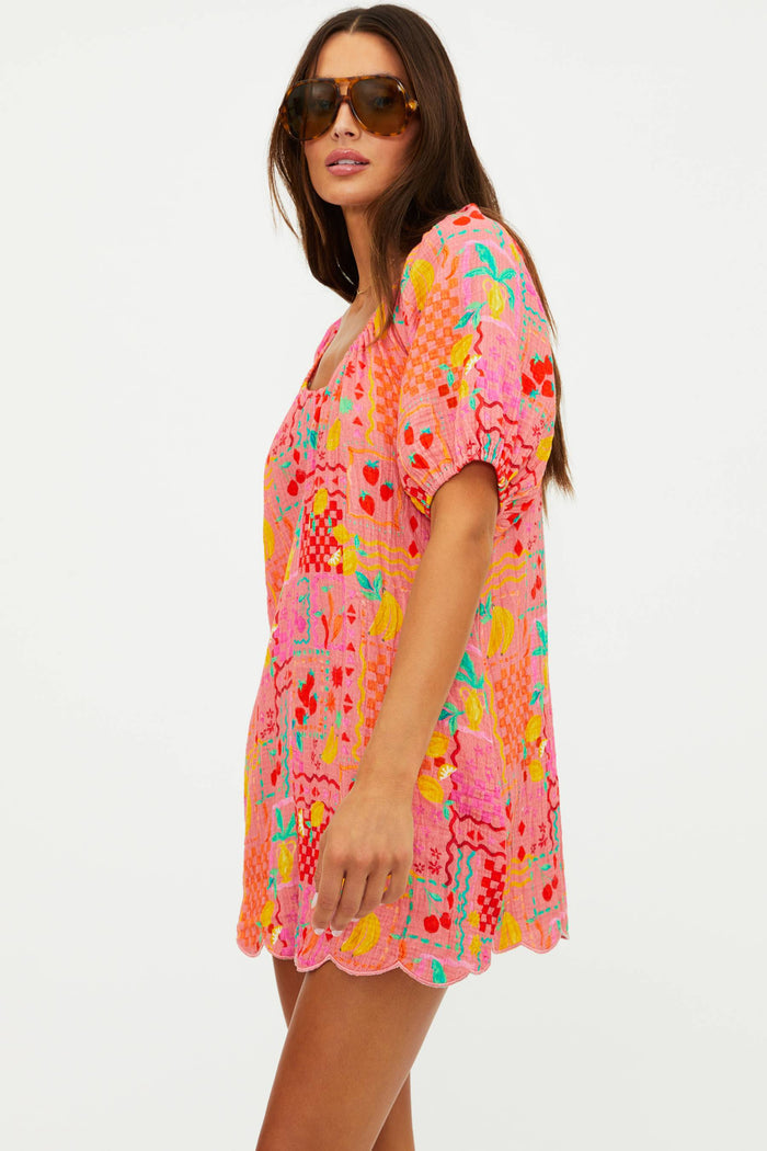 Woman wearing a colorful floral dress on a white background
