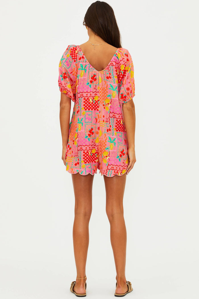 Woman wearing a colorful patterned dress on a white background
