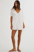 Woman wearing a white lace dress on a white background