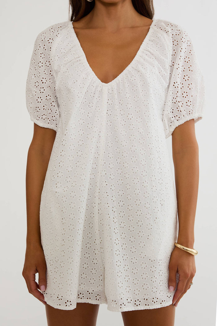 White lace dress worn by a model on a white background