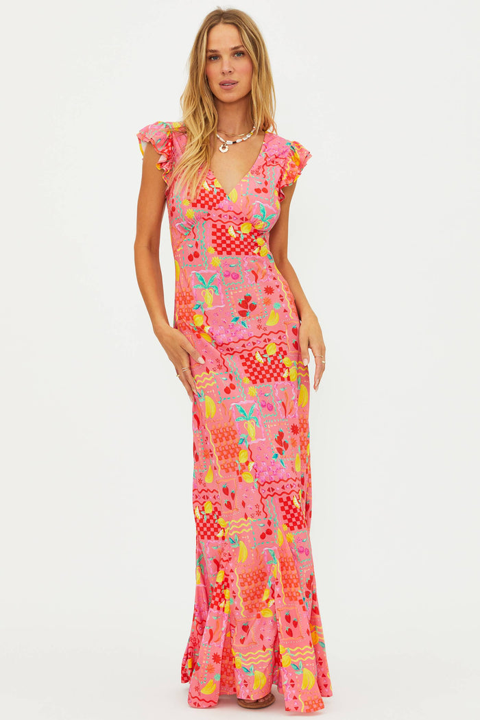 Woman wearing a colorful patterned dress on a white background