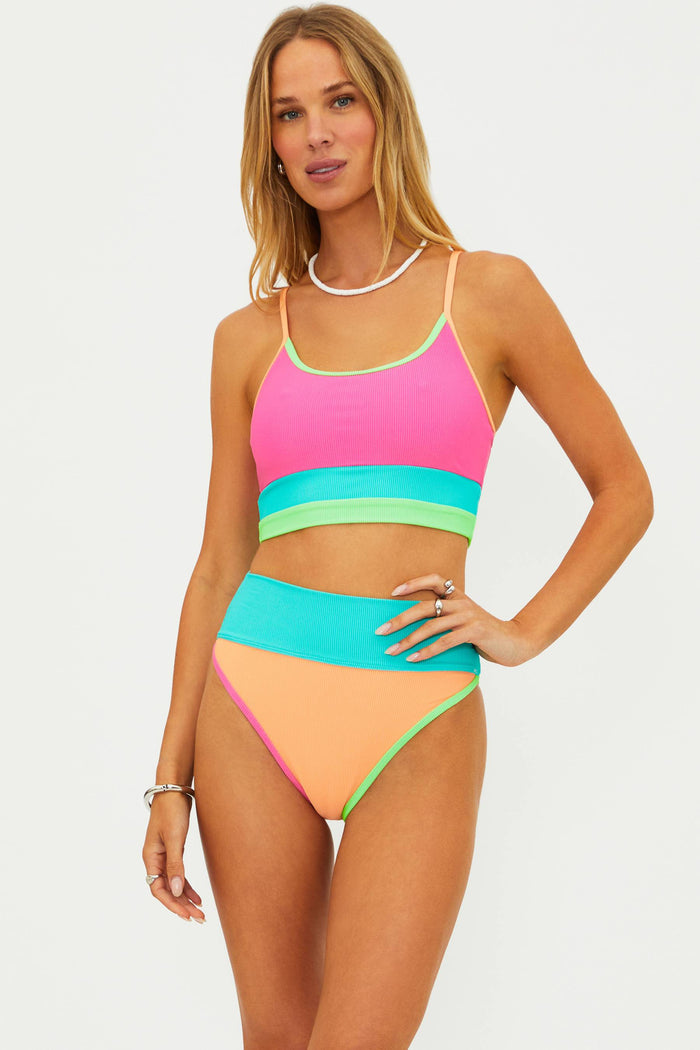 Woman wearing a colorful bikini set on a white background