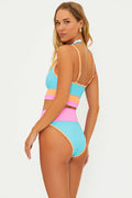 A high-waisted, moderate coverage swim bottom with crush colorblock design, featuring ribbed fabric in blue, pink, and orange.