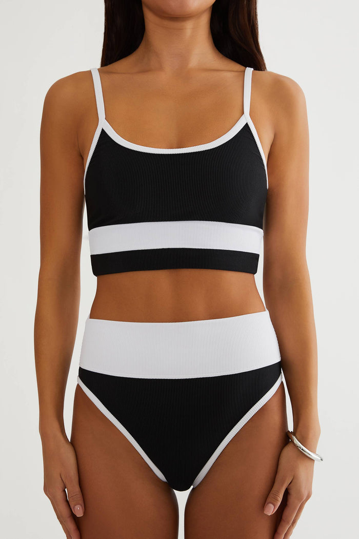 Black and white striped bikini set on a plain background