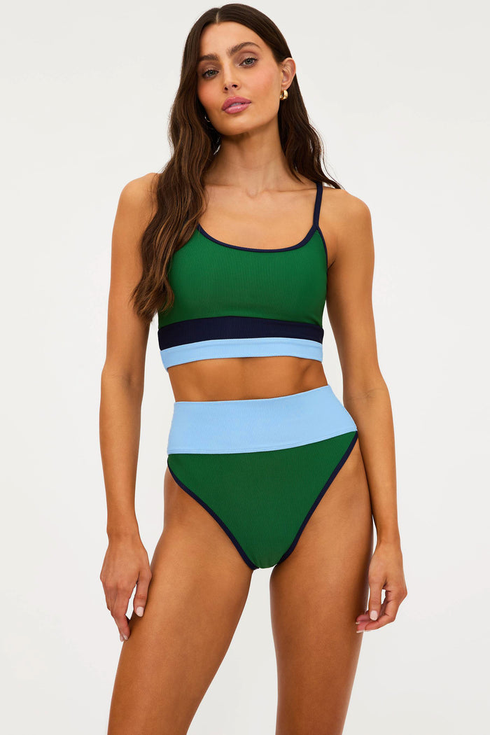 Woman wearing a colorful two-piece swimsuit on a white background