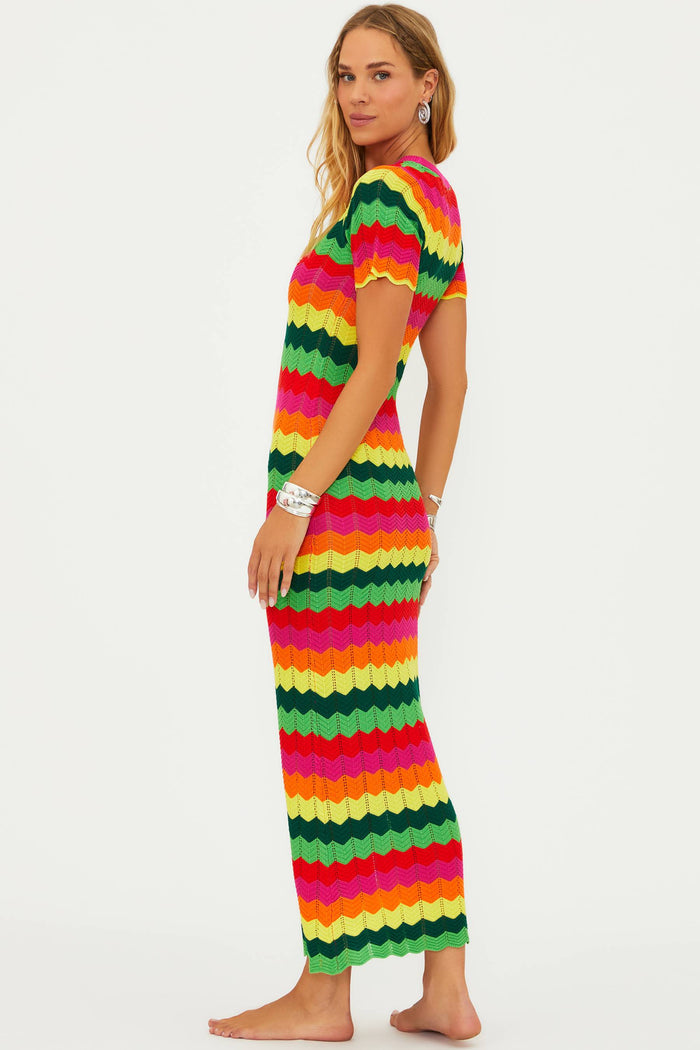 A model wearing a colorful striped maxi dress with cap sleeves.