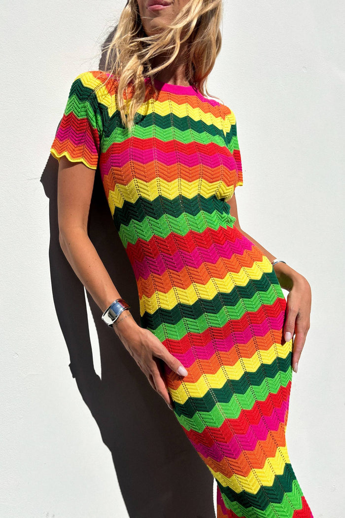 A model wearing a colorful striped maxi dress with cap sleeves.
