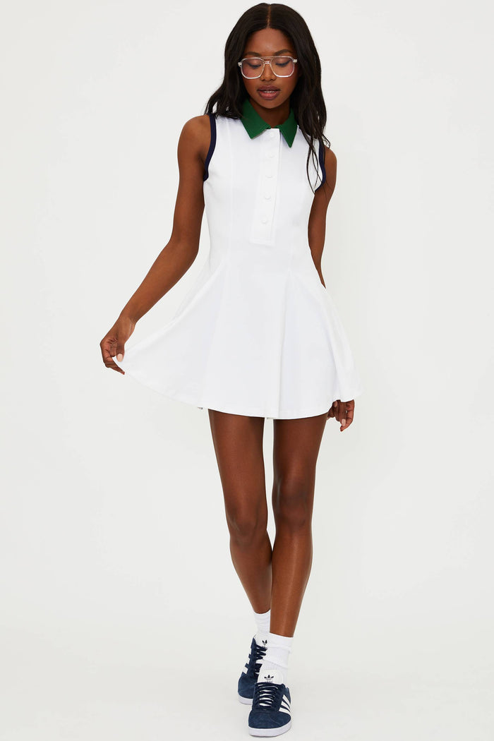 Woman wearing a white dress with green collar on a white background