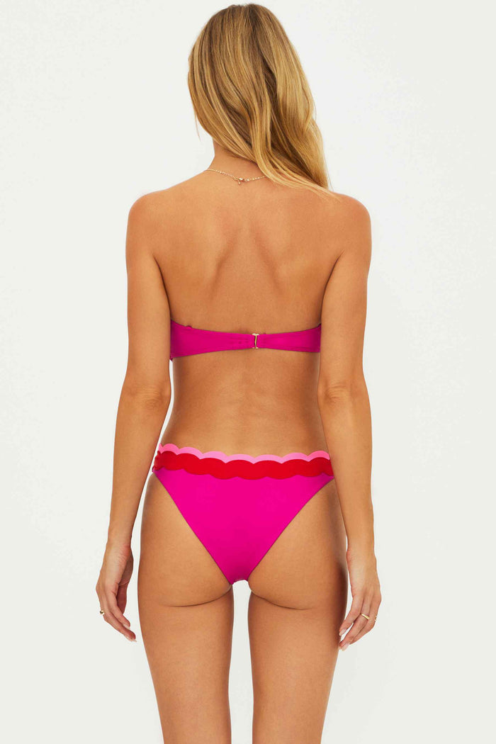 Woman wearing a pink bikini on a white background