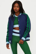 Woman wearing a blue and green tracksuit with a white background