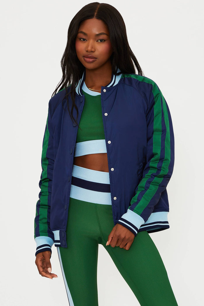 Woman wearing a blue and green tracksuit with a white background