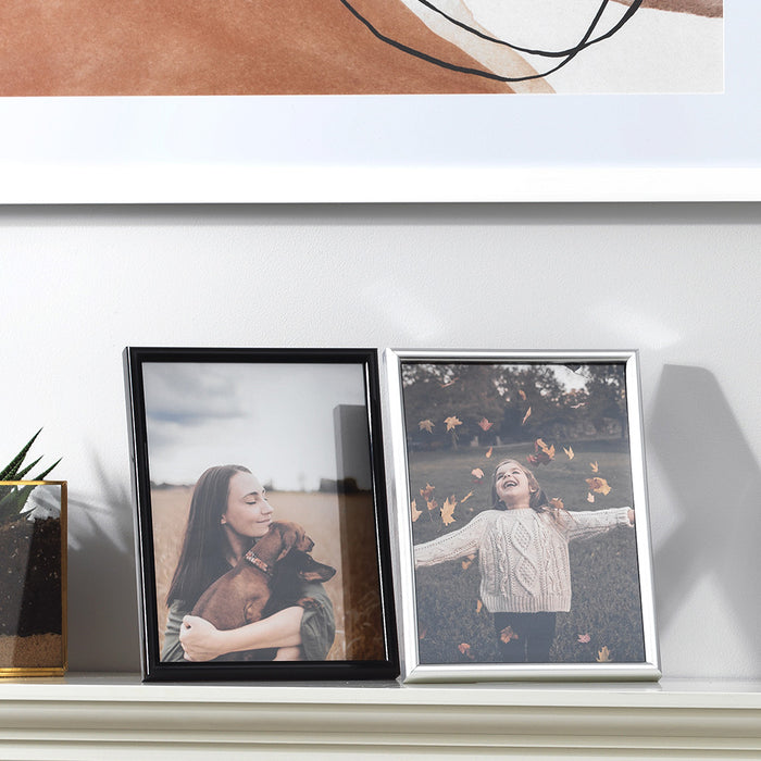 Frisco Plastic black and silver photo frames on shelf with portrait photographs in