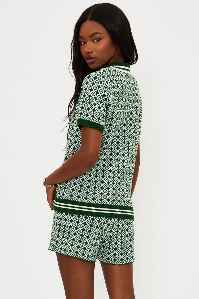 Woman wearing a green and white patterned outfit on a plain background