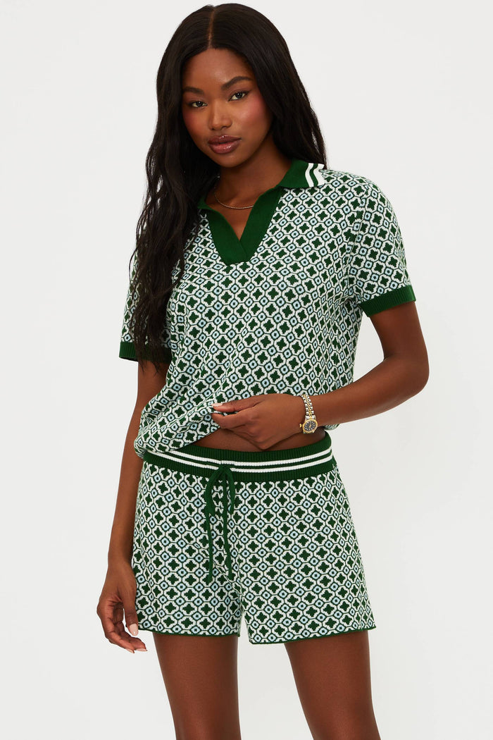 Woman wearing a green and white patterned outfit on a white background